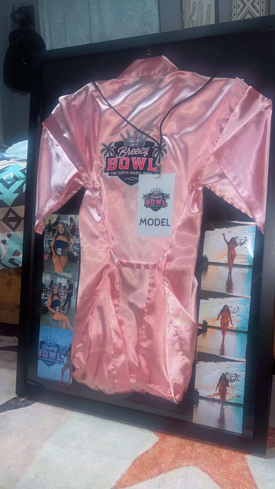 Breezy Bowl Commemorative Frame featuring pink satin robe, model pass, and runway photos